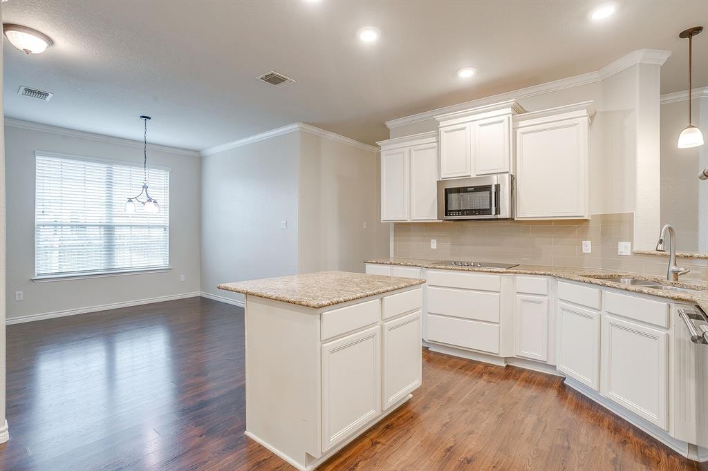 1225 Drummond Circle Waco, TX 76712 - Photo 12 of 40 a kitchen with stainless steel appliances granite countertop white cabinets a sink and dishwasher with wooden floor