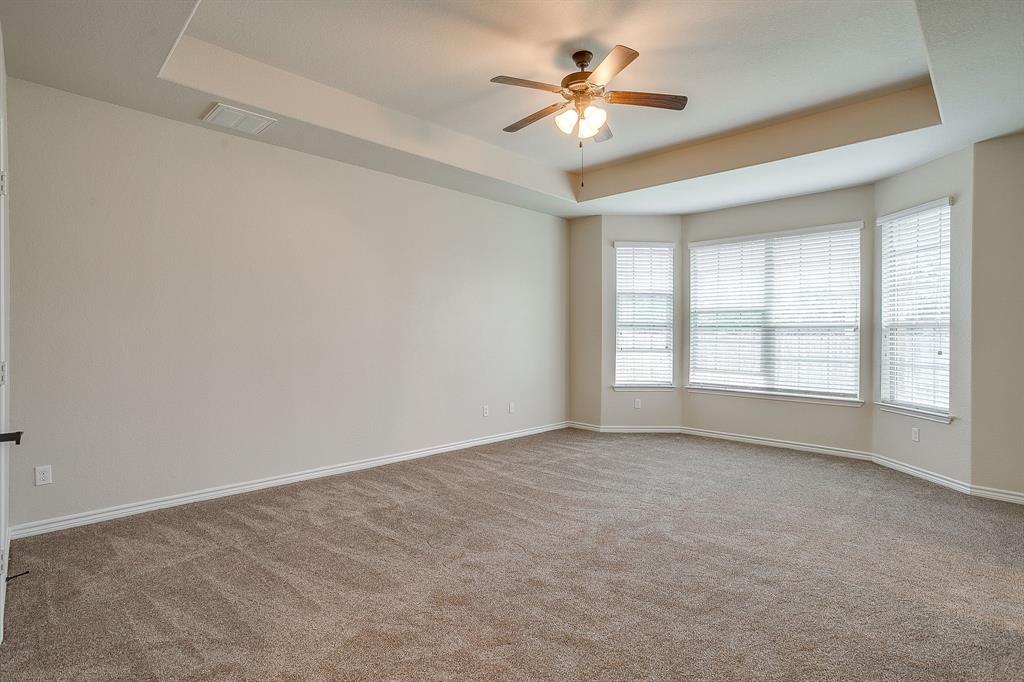 1225 Drummond Circle Waco, TX 76712 - Photo 16 of 40 an empty room with chandelier fan and windows