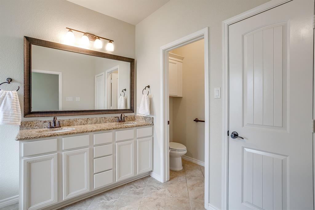 1225 Drummond Circle Waco, TX 76712 - Photo 18 of 40 a bathroom with a double vanity sink and a mirror