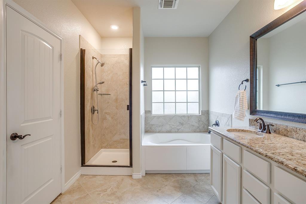 1225 Drummond Circle Waco, TX 76712 - Photo 19 of 40 a bathroom with a granite countertop tub shower and sink