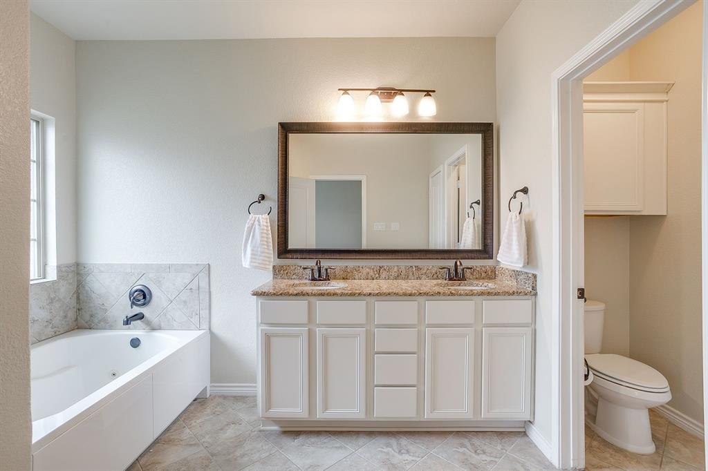 1225 Drummond Circle Waco, TX 76712 - Photo 20 of 40 a bathroom with a toilet sink and mirror