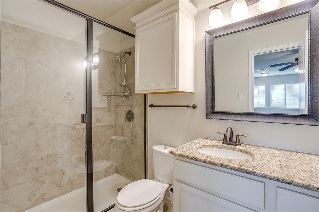 1225 Drummond Circle Waco, TX 76712 - Photo 28 of 40 a bathroom with a granite countertop sink toilet and shower