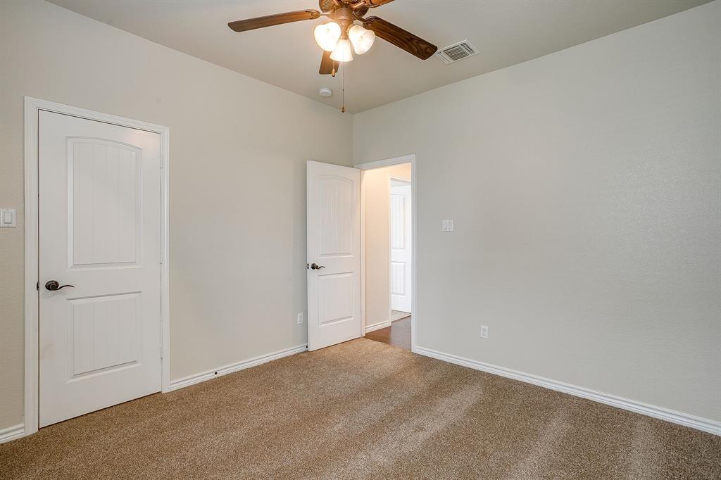 1225 Drummond Circle Waco, TX 76712 - Photo 32 of 40 an empty room with a chandelier fan and a ceiling fan