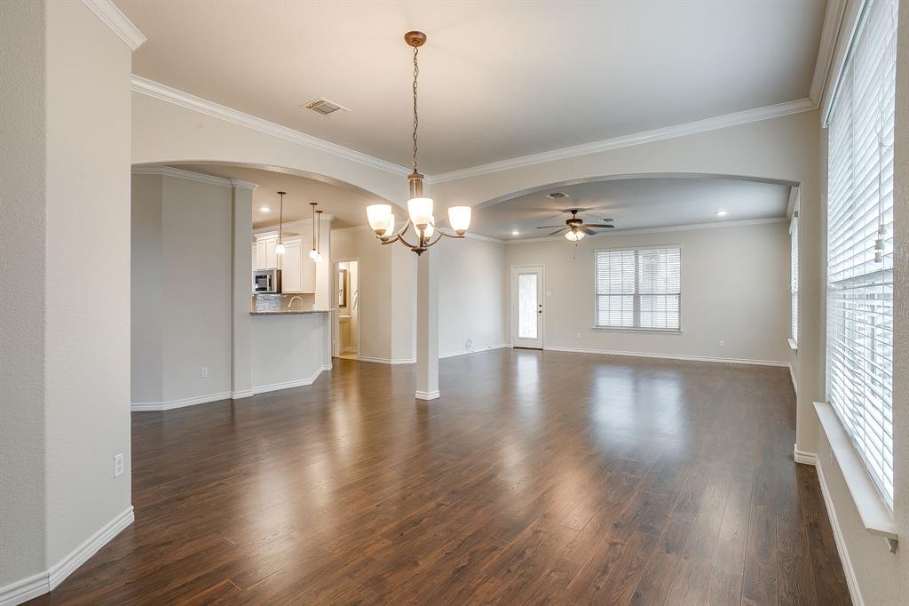 1225 Drummond Circle Waco, TX 76712 - Photo 6 of 40 a view of a livingroom with a hardwood floor ceiling fan and windows