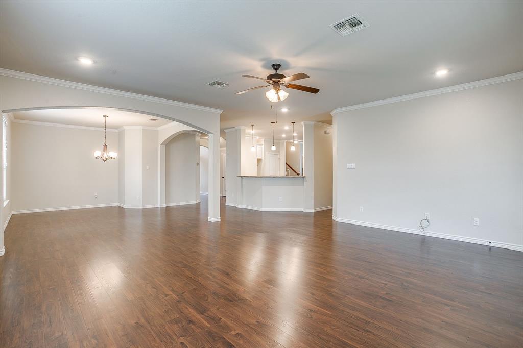 1225 Drummond Circle Waco, TX 76712 - Photo 7 of 40 an empty room with wooden floor chandelier fan and windows