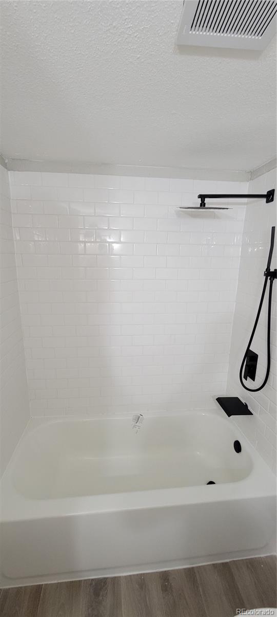 12140 Huron Street, Unit 101 Denver, CO 80234 - Photo 11 of 19 a bathroom with a bathtub