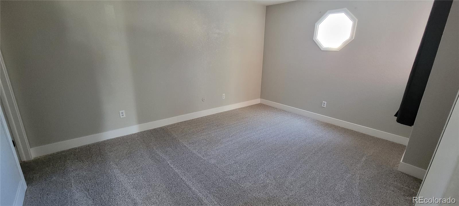 12140 Huron Street, Unit 101 Denver, CO 80234 - Photo 16 of 19 an empty room with wooden floor and windows