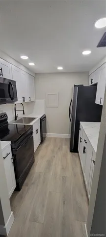 a kitchen with stainless steel appliances a refrigerator and a sink