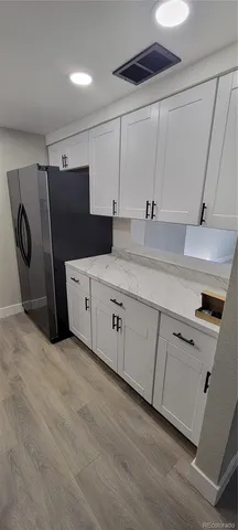 a kitchen with stainless steel appliances a sink and a refrigerator