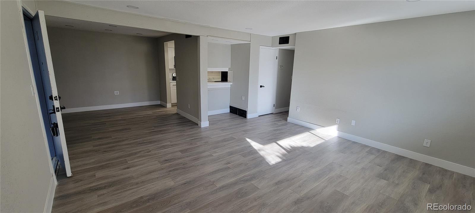 12140 Huron Street, Unit 101 Denver, CO 80234 - Photo 6 of 19 wooden floor in an empty room with a window