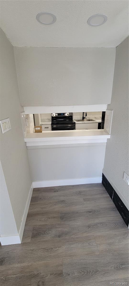 12140 Huron Street, Unit 101 Denver, CO 80234 - Photo 7 of 19 a view of kitchen with wooden floor