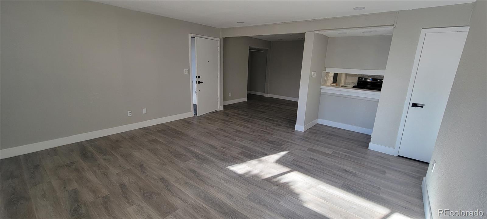 12140 Huron Street, Unit 101 Denver, CO 80234 - Photo 8 of 19 a view of a hallway with wooden floor and closet