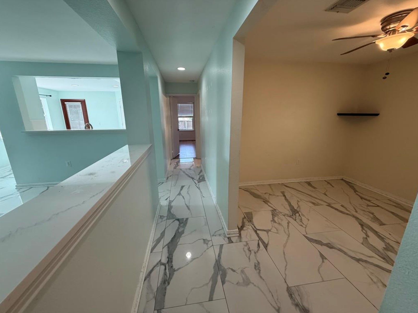 6600 Glebe Path Austin, TX 78754 - Photo 8 of 11 Marble-look tile flooring extends through this home, offering a pristine and easy-to-maintain living space.