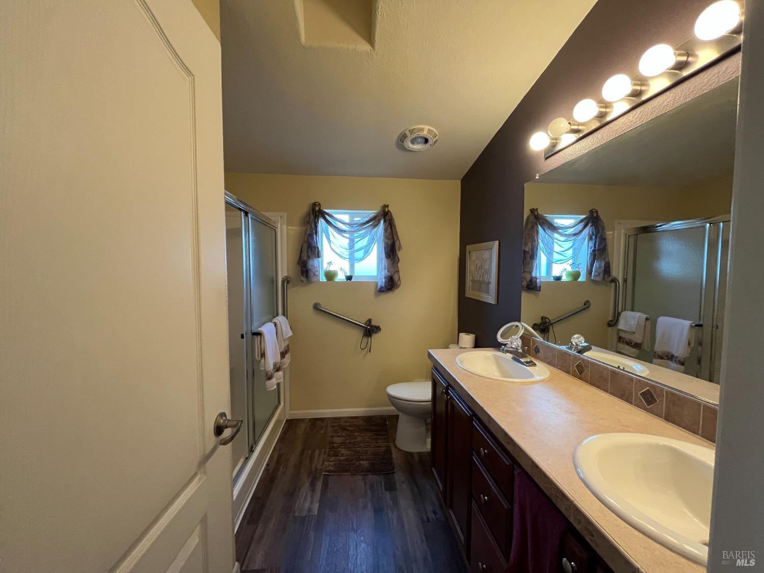 54 Norfolk Drive Santa Rosa, CA 95401 - Photo 38 of 57 a en suite bathroom with a granite countertop sink toilet and a mirror