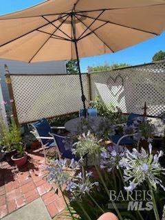 54 Norfolk Drive Santa Rosa, CA 95401 - Photo 42 of 57 a picture of a table and chairs under an umbrella