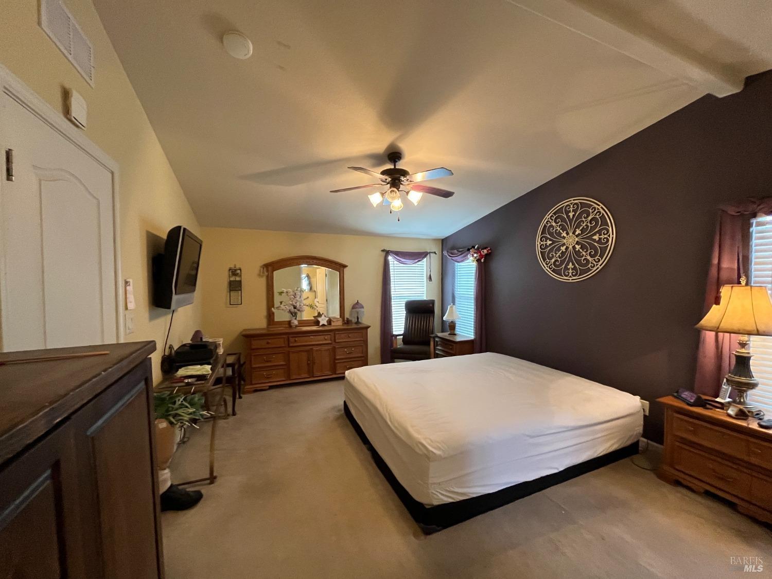 54 Norfolk Drive Santa Rosa, CA 95401 - Photo 44 of 57 a spacious bedroom with a bed and a chandelier