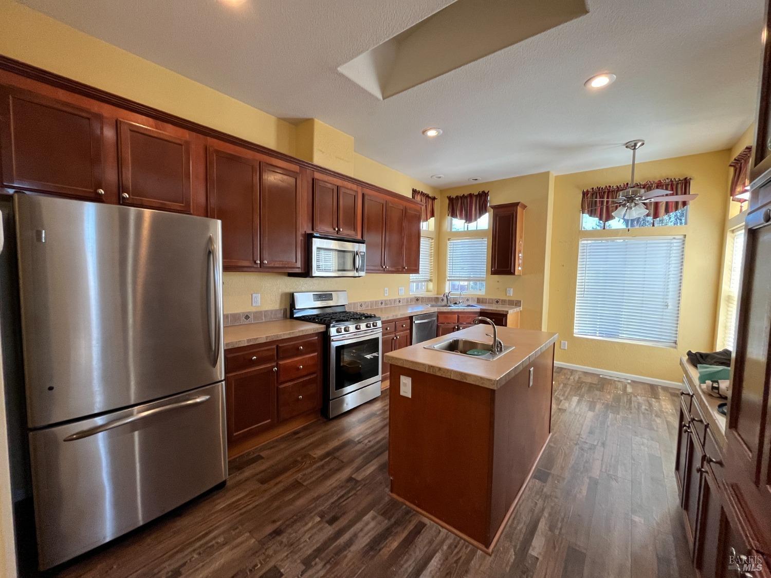 54 Norfolk Drive Santa Rosa, CA 95401 - Photo 6 of 57 a kitchen with stainless steel appliances granite countertop a refrigerator a sink dishwasher a stove and a refrigerator