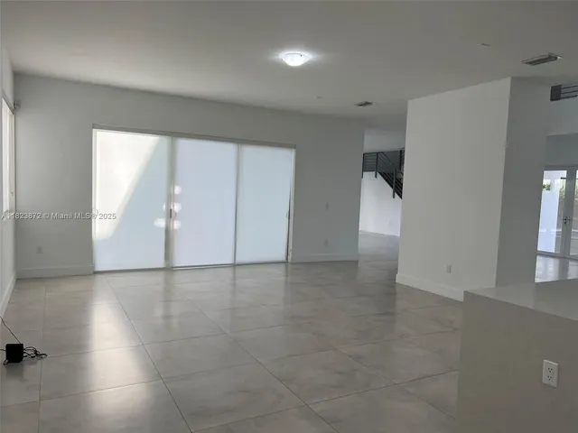 an empty room with windows and entrance