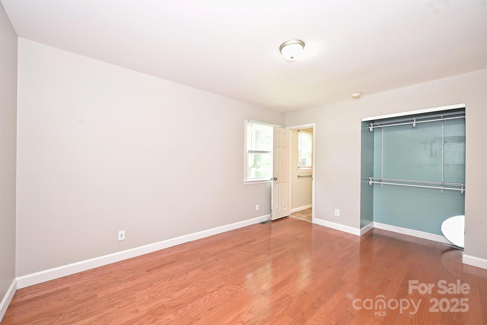 3729 Woodleaf Road Charlotte, NC 28205 - Photo 12 of 23 a view of an empty room with wooden floor and a window