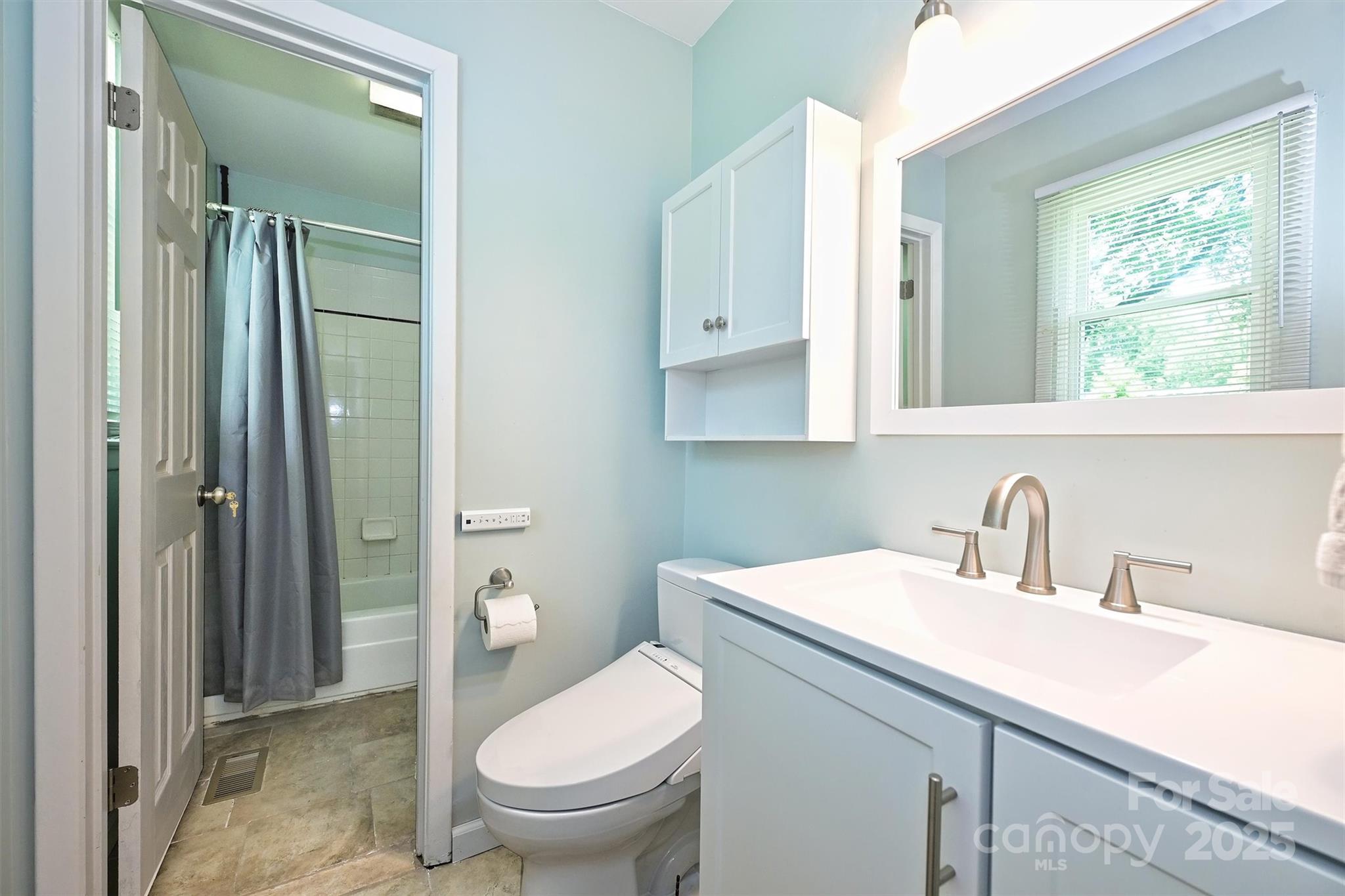 3729 Woodleaf Road Charlotte, NC 28205 - Photo 16 of 23 a bathroom with a granite countertop sink toilet and shower