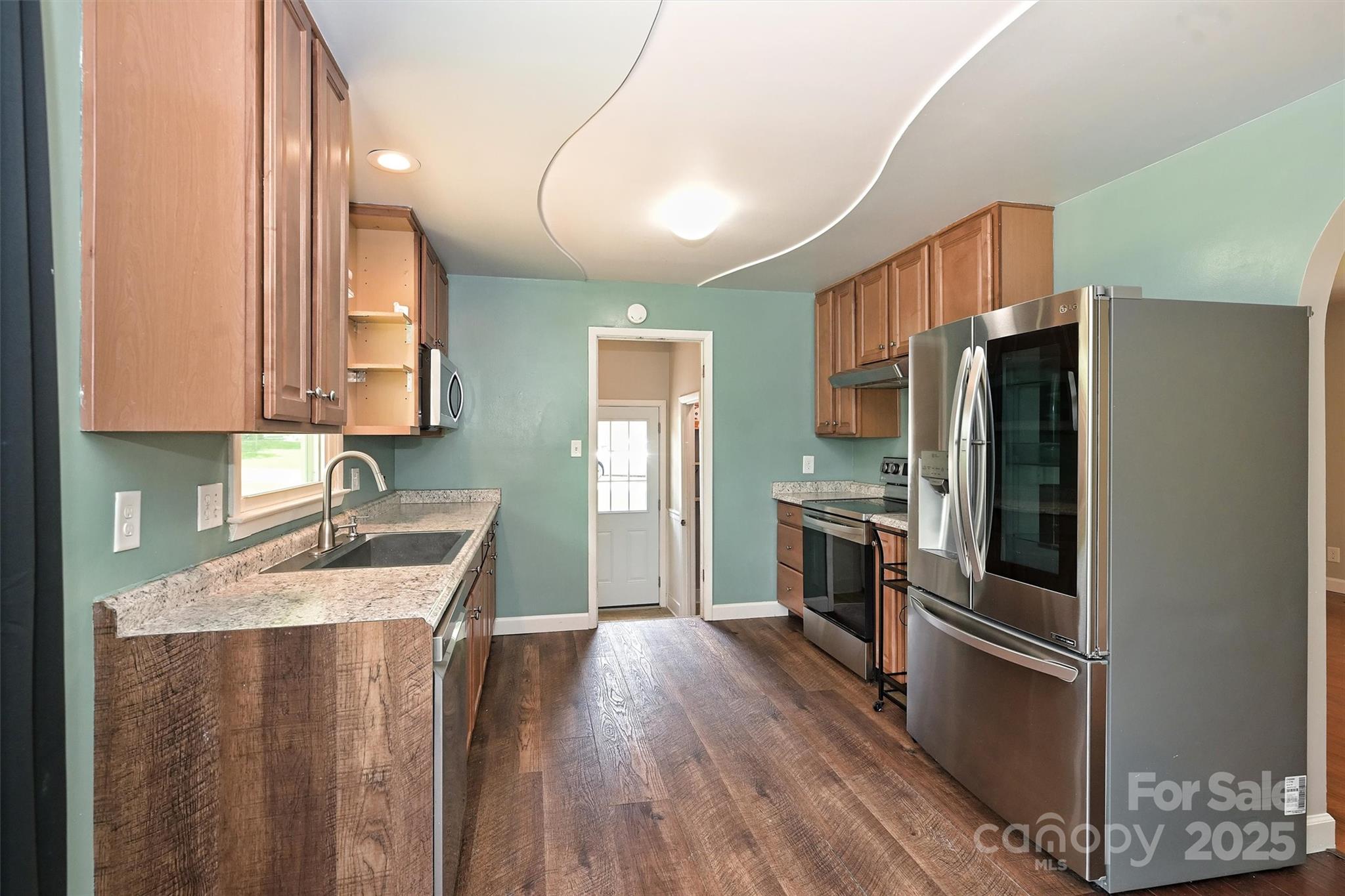 3729 Woodleaf Road Charlotte, NC 28205 - Photo 7 of 23 a kitchen with a refrigerator sink and stove