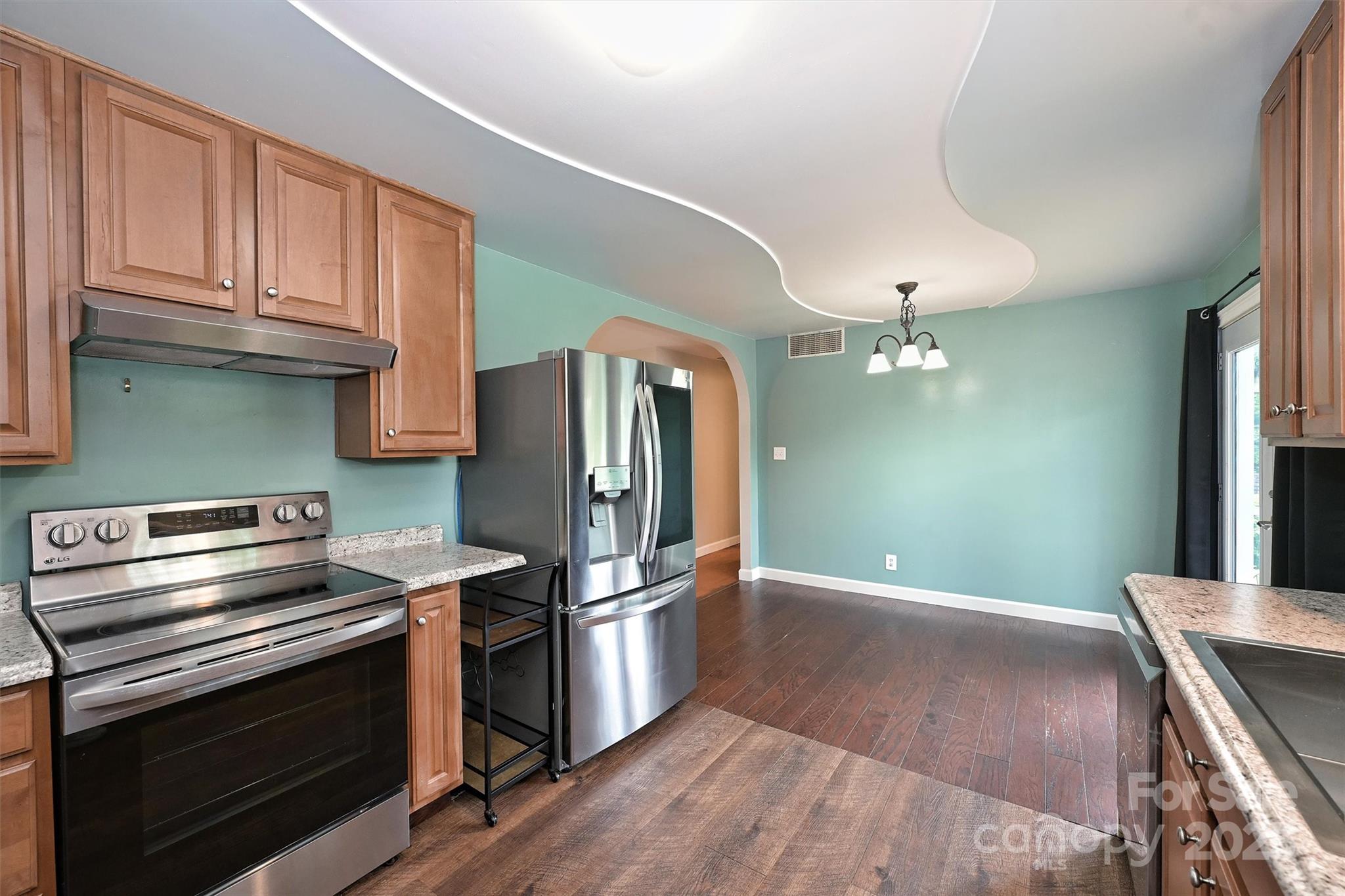 3729 Woodleaf Road Charlotte, NC 28205 - Photo 9 of 23 a kitchen with a sink stainless steel appliances and cabinets