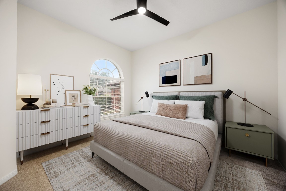 13735 Sablegarden Lane Houston, TX 77014 - Photo 14 of 20 Spacious and thoughtfully designed secondary bedroom showcasing a stunning arched window that fills the space with natural light. Soft neutral tones, modern furnishings, and a serene atmosphere make this room ideal for guests, a home office, or a peaceful personal retreat. A beautifully curated space that adds both comfort and style to the home.