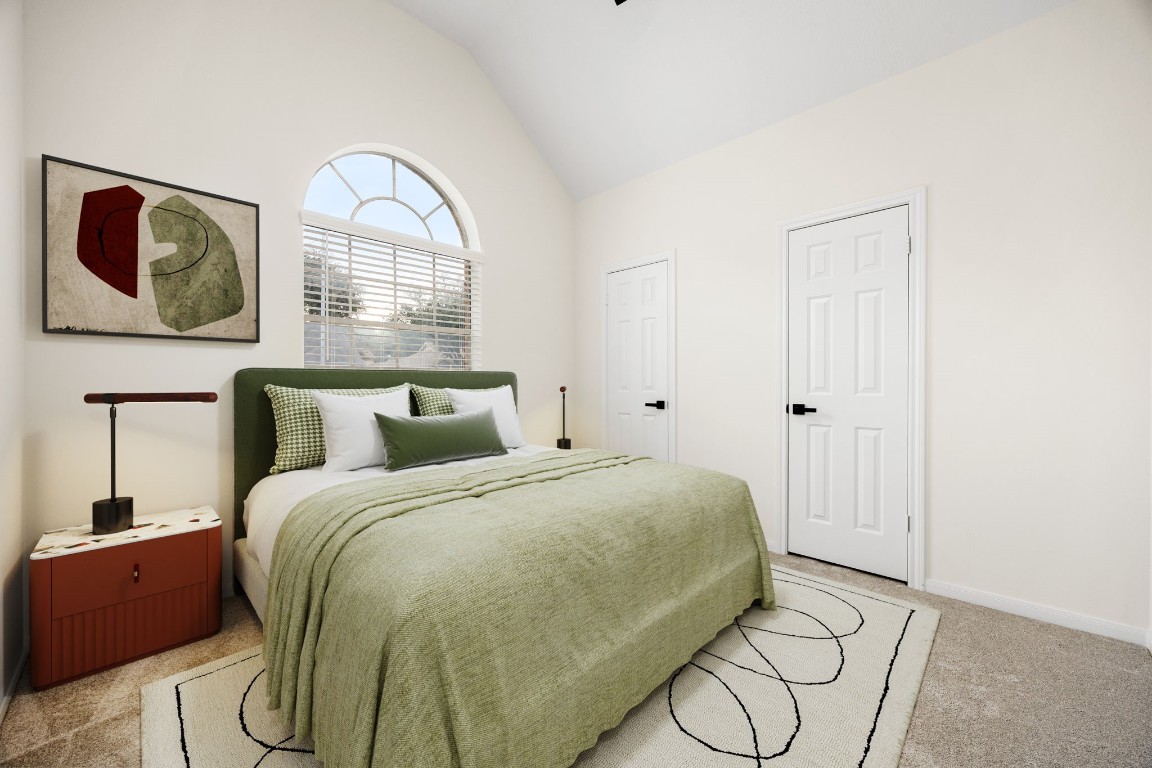13735 Sablegarden Lane Houston, TX 77014 - Photo 15 of 20 nviting bedroom featuring a vaulted ceiling and a beautiful arched window that fills the space with natural light. Soft neutral tones pair seamlessly with the modern staging, creating a fresh and relaxing atmosphere. With two closets for added storage and a spacious layout, this room works perfectly as a guest suite, office, or cozy retreat.