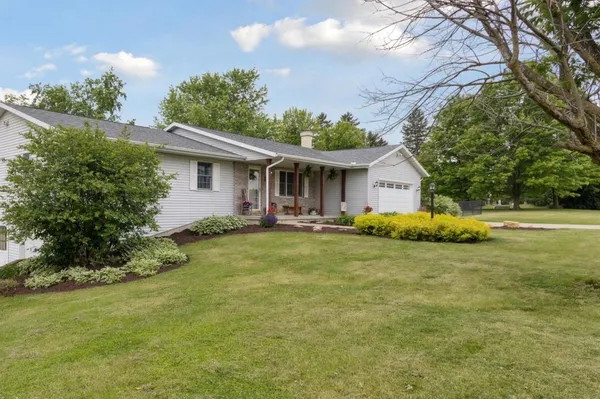 a front view of house with yard and green space