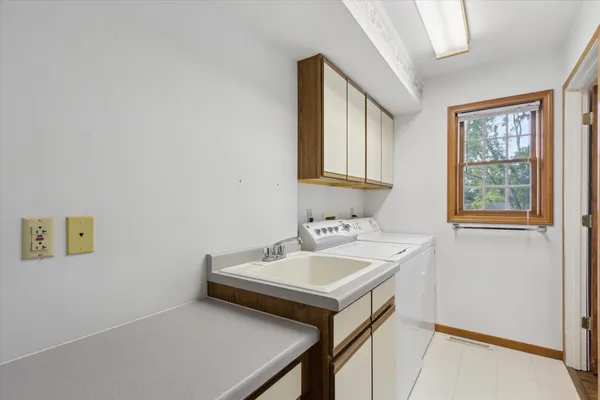 a utility room with a sink dryer and washer