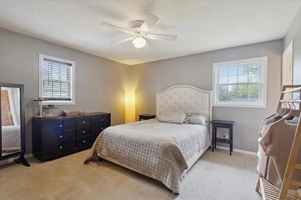 a bedroom with a bed and a chandelier