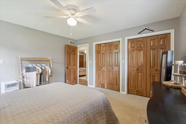 a bedroom with a large bed and a chandelier