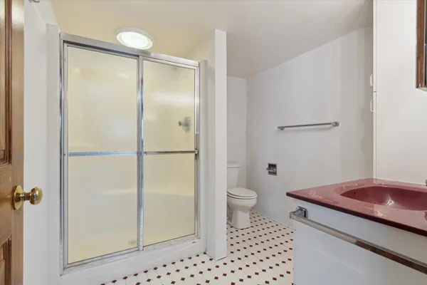 a bathroom with a sink toilet and shower