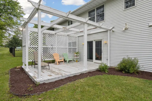 a view of a house with backyard and sitting area