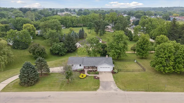 an aerial view of a house with a yard