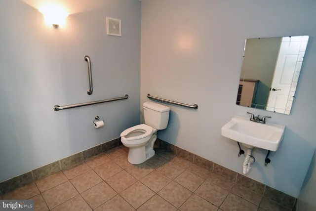 a white toilet sitting next to a bathroom sink