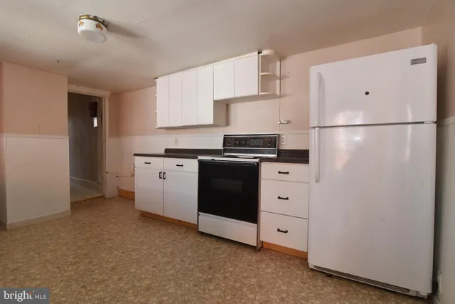 a kitchen with cabinets appliances and a counter space