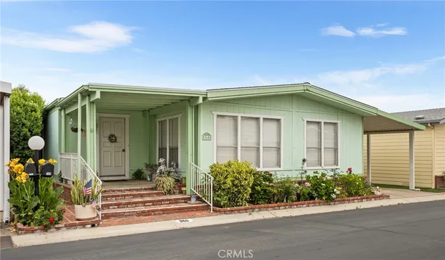front view of a house with potted plants