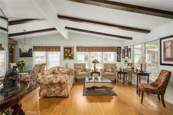 a living room with furniture and hard wood flooring