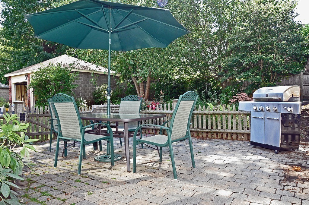 69 Reedsdale Road Milton, MA 02186 - Photo 11 of 13 a view of a chairs and table under an umbrella