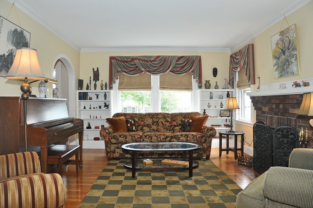 69 Reedsdale Road Milton, MA 02186 - Photo 3 of 13 a living room with furniture a fireplace and a large window