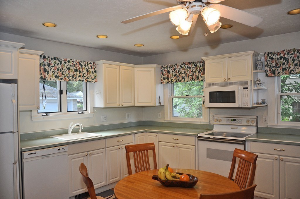69 Reedsdale Road Milton, MA 02186 - Photo 7 of 13 a kitchen with a chandelier furniture and a stove