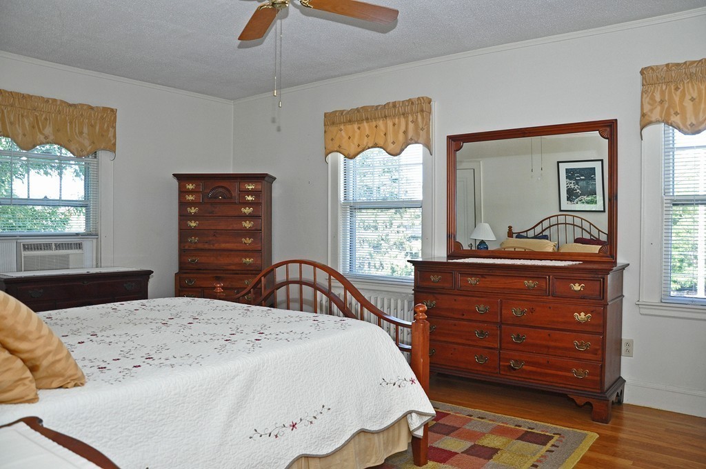 69 Reedsdale Road Milton, MA 02186 - Photo 9 of 13 a bedroom with a bed and a dresser