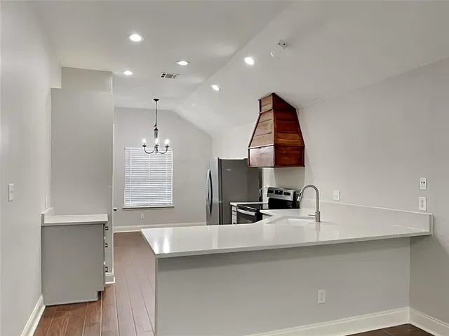 a kitchen with kitchen island a sink and a window