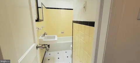 a bathroom with a mirror and a shower