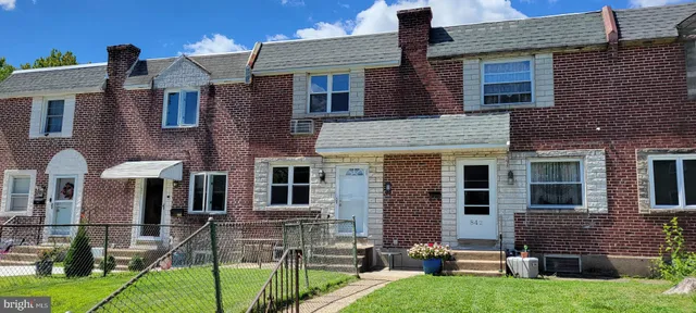 an aerial view of a house with backyard space and garden