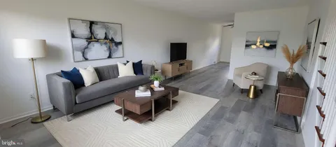 a view of an entryway with wooden floor and stairs