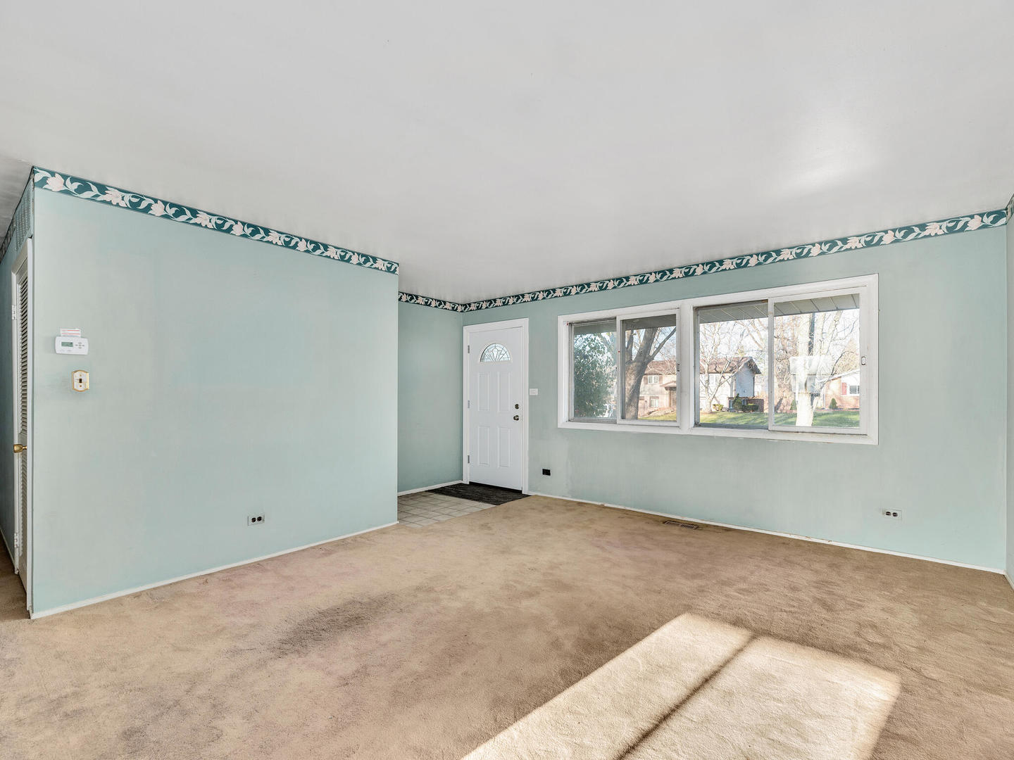 21W241 Coronet Road Lombard, IL 60148 - Photo 3 of 24 a view of an empty room with a window