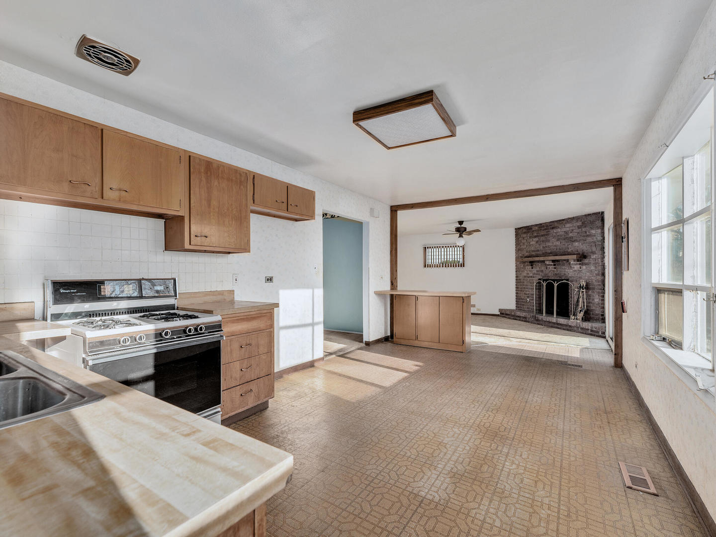 21W241 Coronet Road Lombard, IL 60148 - Photo 7 of 24 a kitchen with stainless steel appliances granite countertop a stove top oven a sink a counter space and cabinets