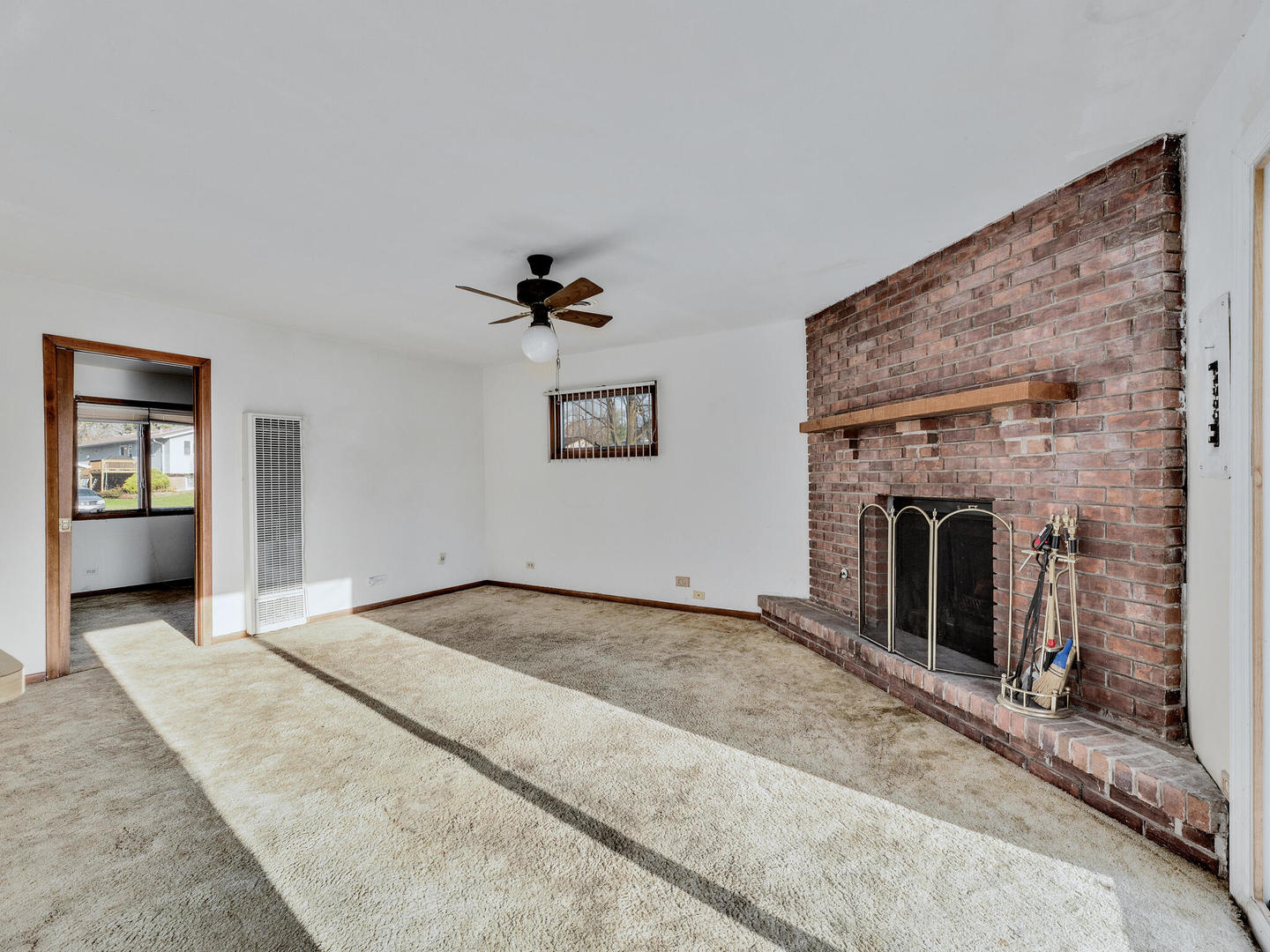 21W241 Coronet Road Lombard, IL 60148 - Photo 10 of 24 a view of a livingroom with a fireplace and window